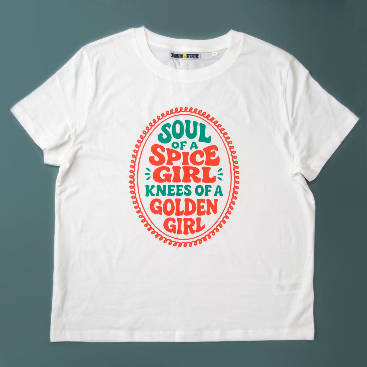 White t-shirt with colorful text design on a gray background