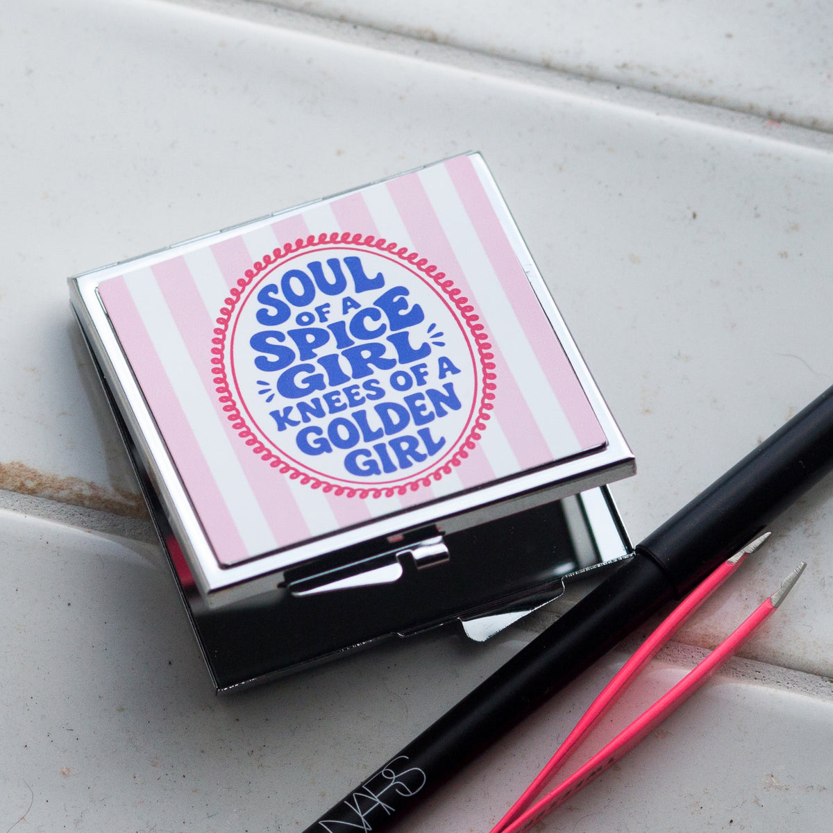 square compact mirror with pink stripes and the slogan soul of a spice girl, knees of a golden girl