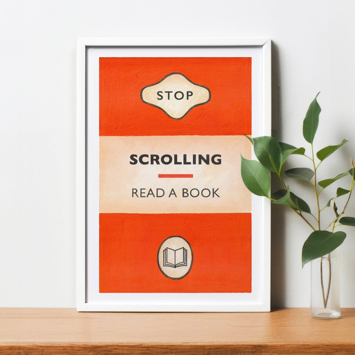 a print of a book cover designed to look like a classic penguin book that is titled stop scrolling read a book in a white frame on a shelf with a plant in a glass jar