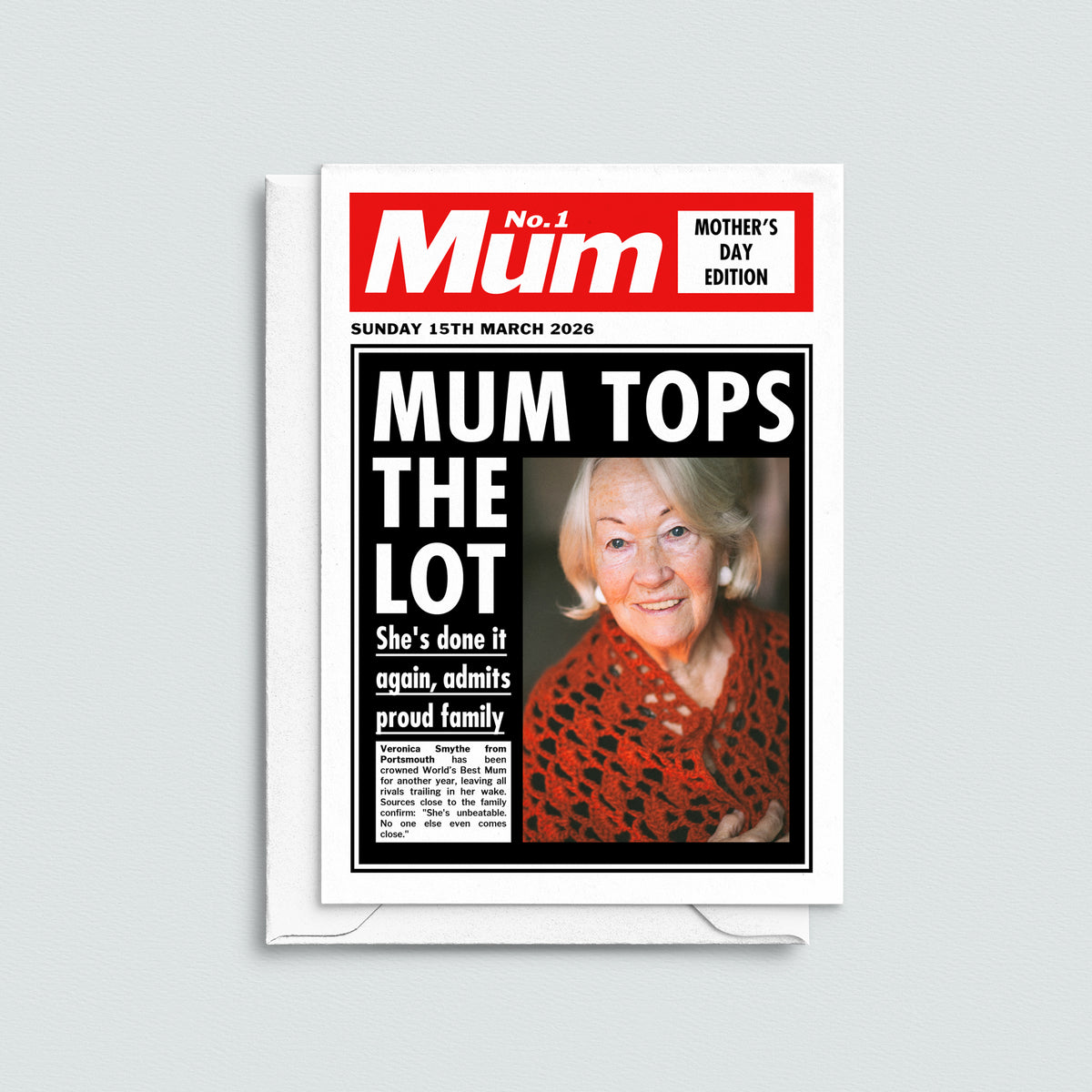 Greeting card with a newspaper-style design featuring a woman on the cover, titled 'Mum Tops the Lot'.
