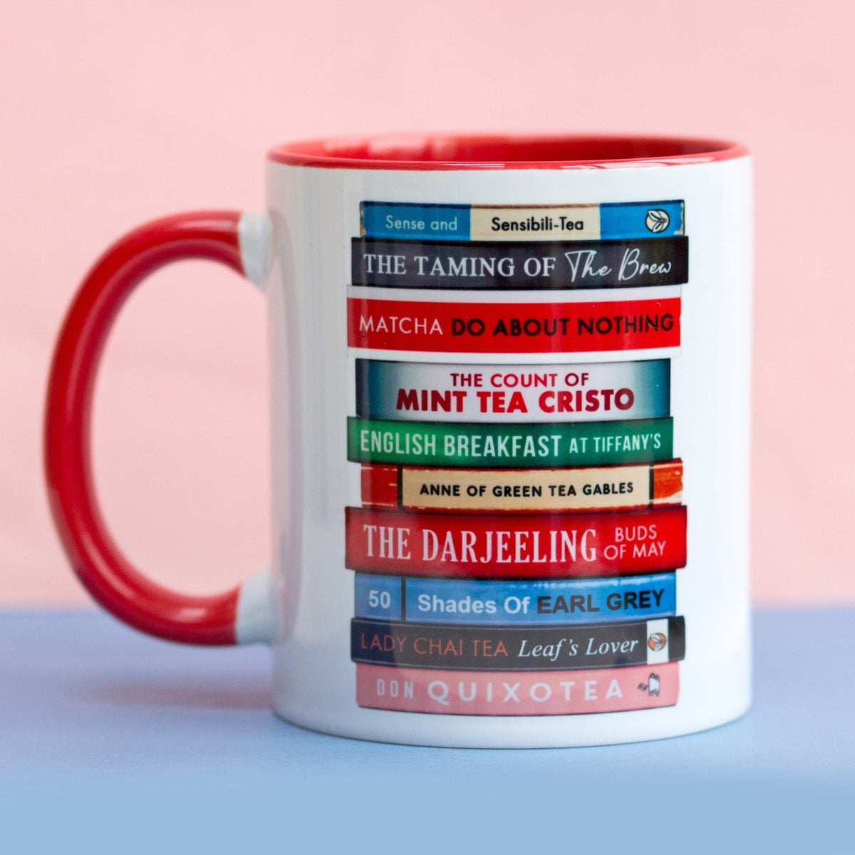 a book themed mug on a pink and blue background