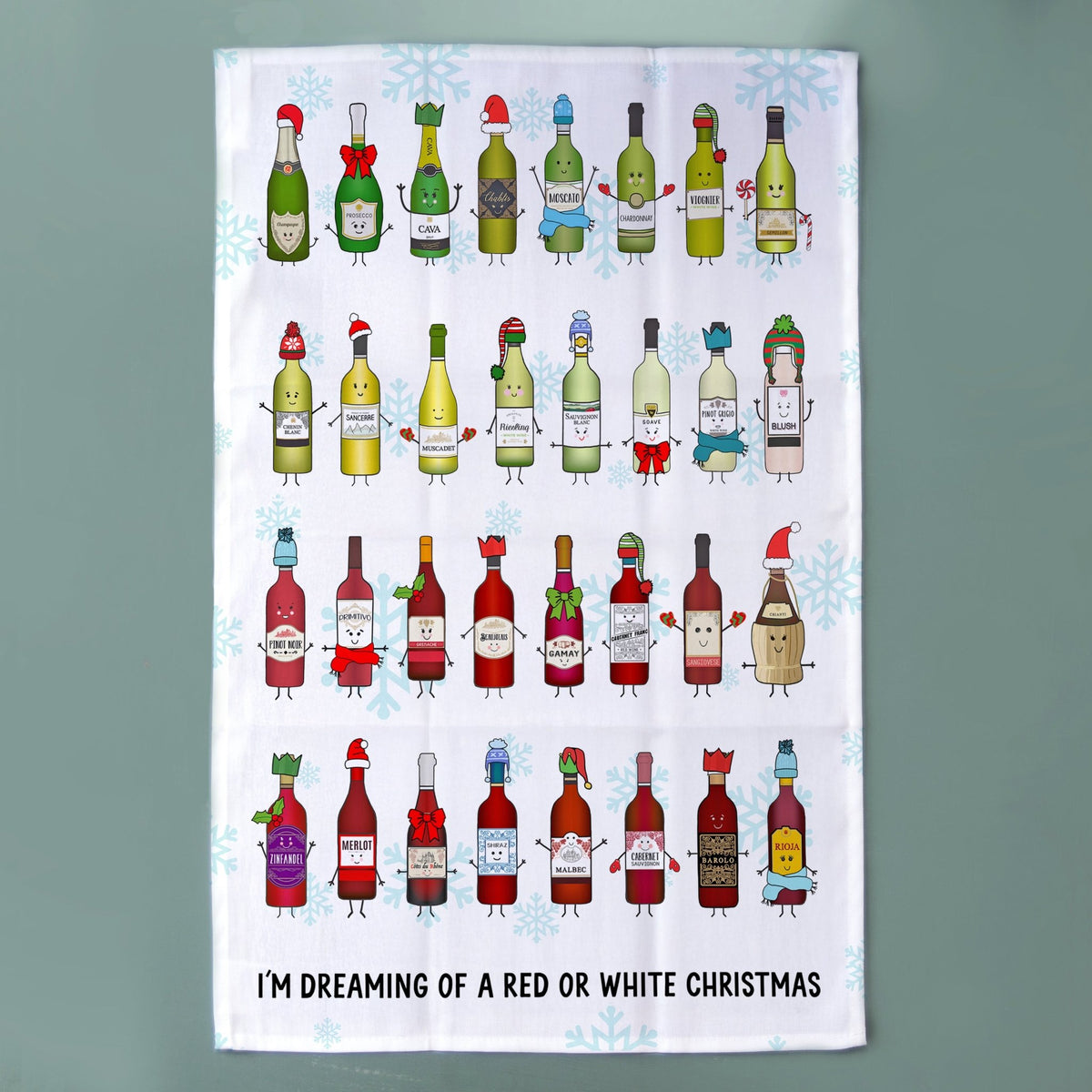 A white tea towel featuring a whimsical illustration of various Christmas wine bottles with faces and limbs, set against a light blue snowflake pattern. The bottom of the towel has the text 'I'M DREAMING OF A RED OR WHITE CHRISTMAS' in black.