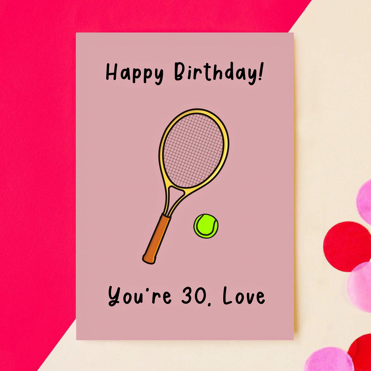 a funny birthday card featuring an illustration of a tennis racket and ball and the words Happy Birthday! You're 30, Love - pictured on a  cream and pink background