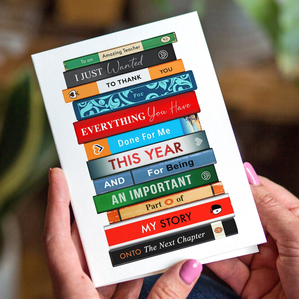 Thank you Card with colorful book design held by hands against a blurred indoor background