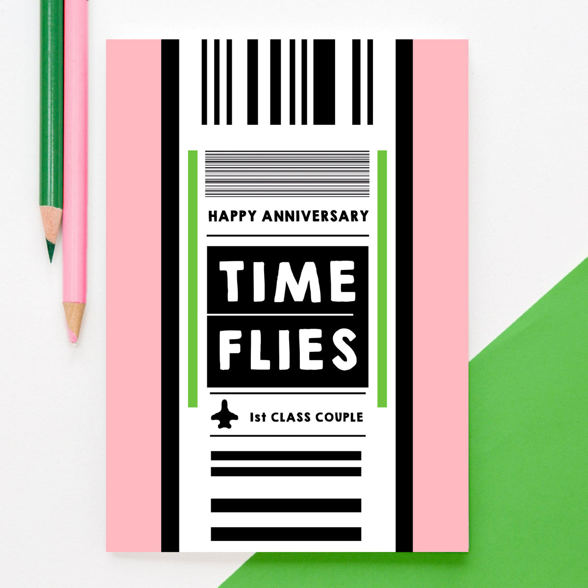 anniversary card designed to look like a luggage label with the words 'time flies' happy anniversary and first class couple, Pictured on a white and green background