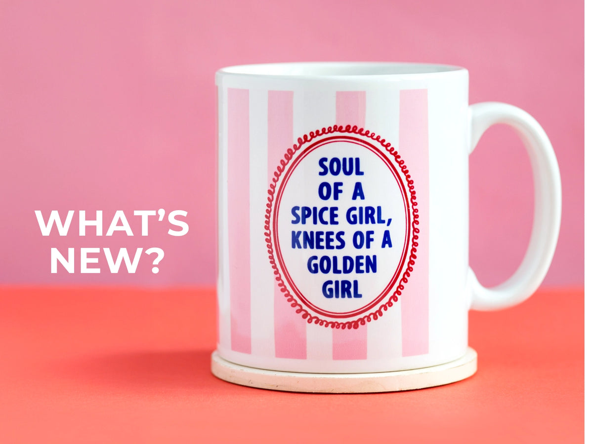 White mug with pink stripes and text on a pink and red background