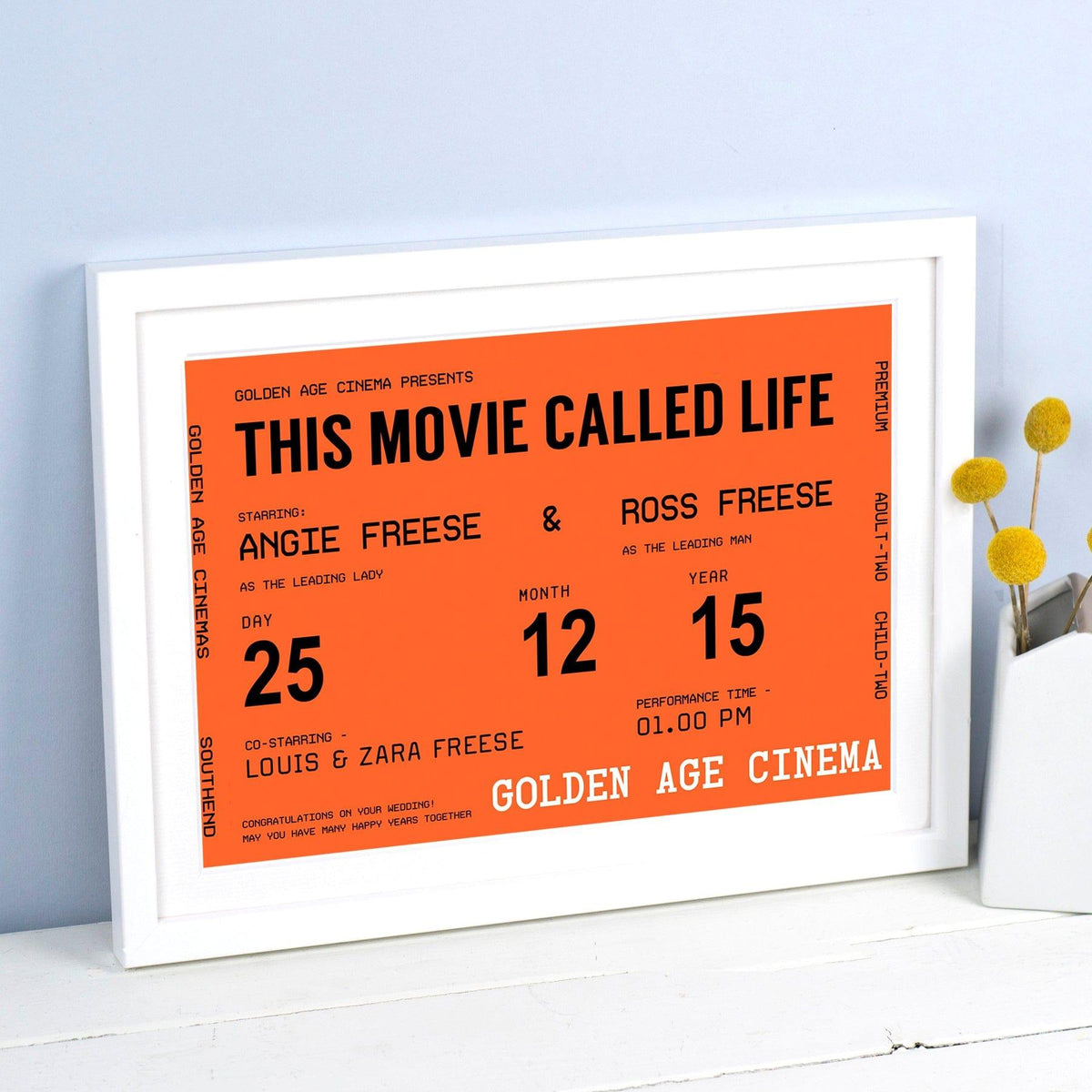 Framed poster with text 'This Movie Called Life' on an orange background, displayed on a white surface.