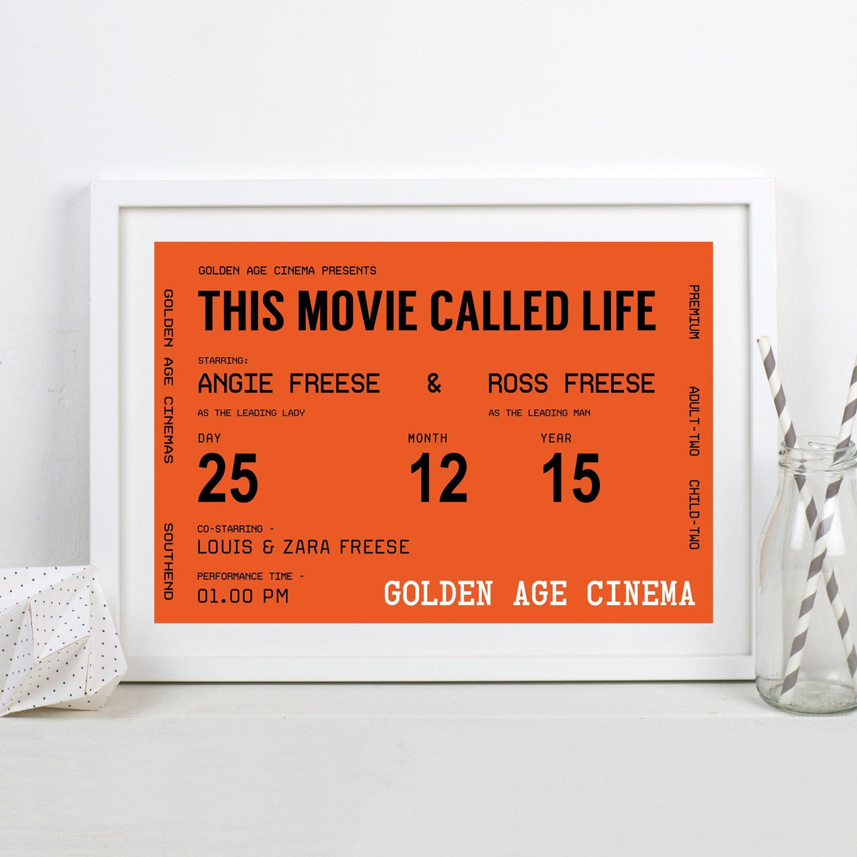 Framed poster with text 'This Movie Called Life' on an orange background, displayed on a white surface.