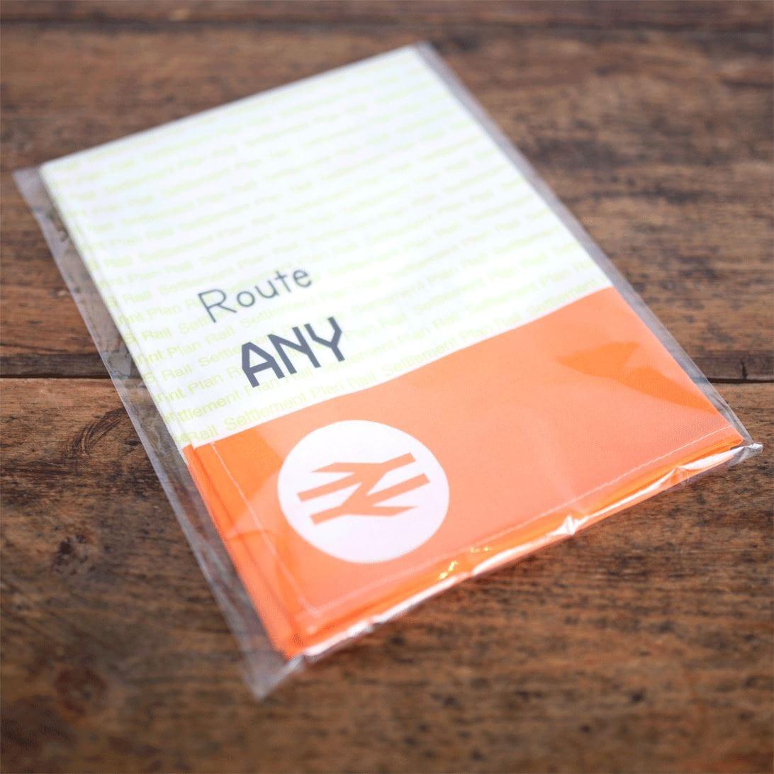 Packaged product with 'Route ANY' text on a wooden surface